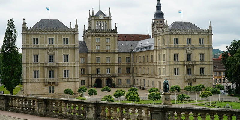 Schloss Ehrenburg, the ducal palace, with its ornate facade, garden and statue