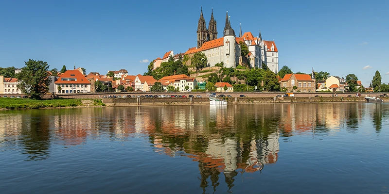 The Albrechtsburg castle and Gothic cathedral on their hill above Meissen, reflected in the Elbe