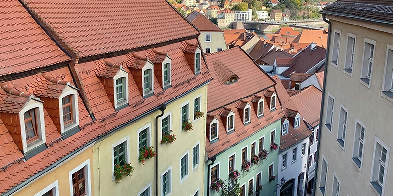 Old town rooftops in Meissen with dormer windows and flower boxes, a view over the town
