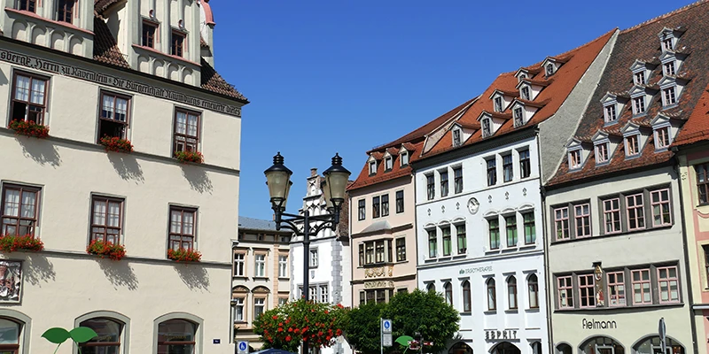 Aerial view over Naumburg's market square with yellow café umbrellas and gabled roofs