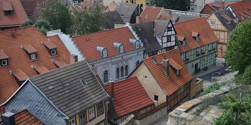 Closely packed tiled rooftops and dormers seen from above