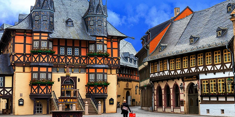 Wernigerode Town Hall with twin pointed turrets, the gilded market fountain and the Gothisches Haus hotel