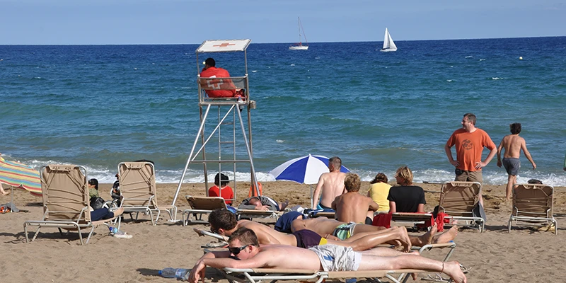 Beach promenade with palm trees along Barceloneta