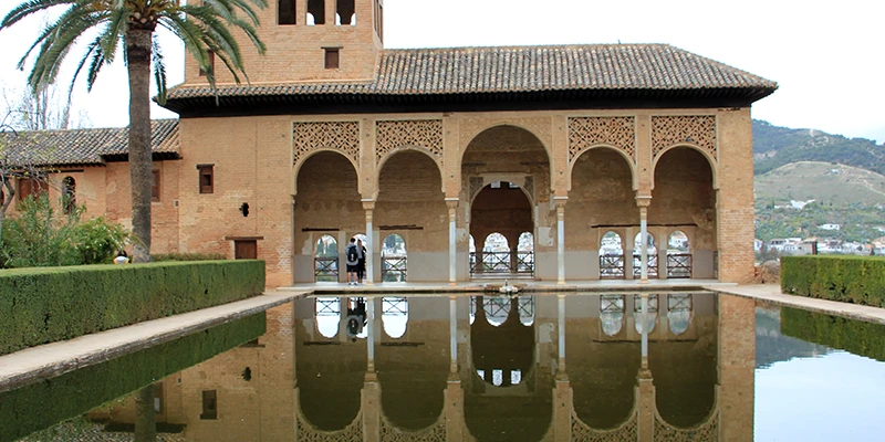 The warm ochre walls of the Alhambra glowing in afternoon light